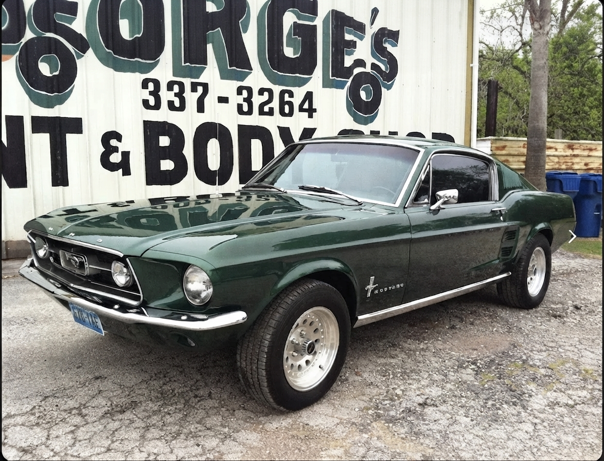 Restored classic green Ford Mustang fastback parked outside George's Paint and Body Shop